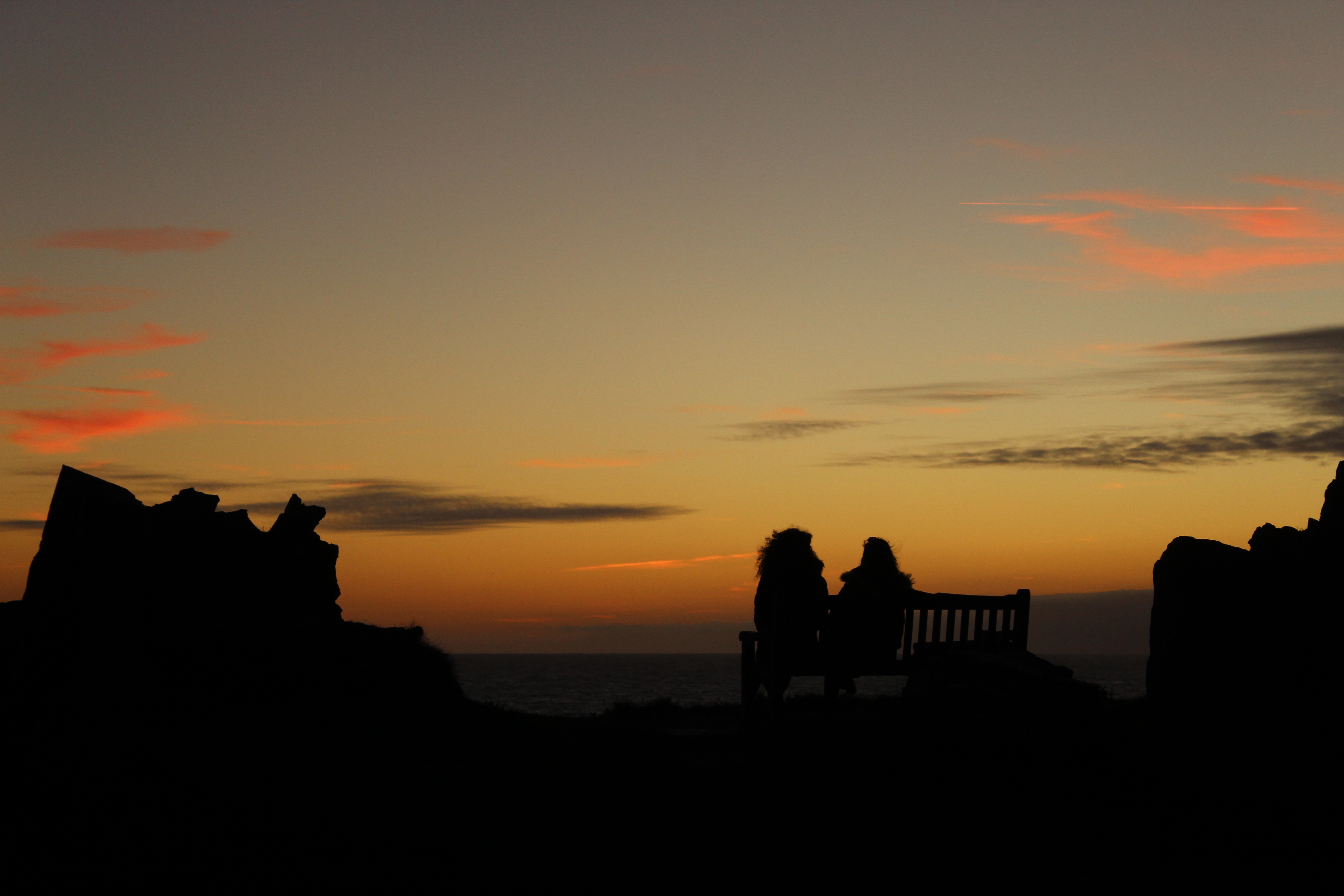 Silhouette of 2 people in the sunset